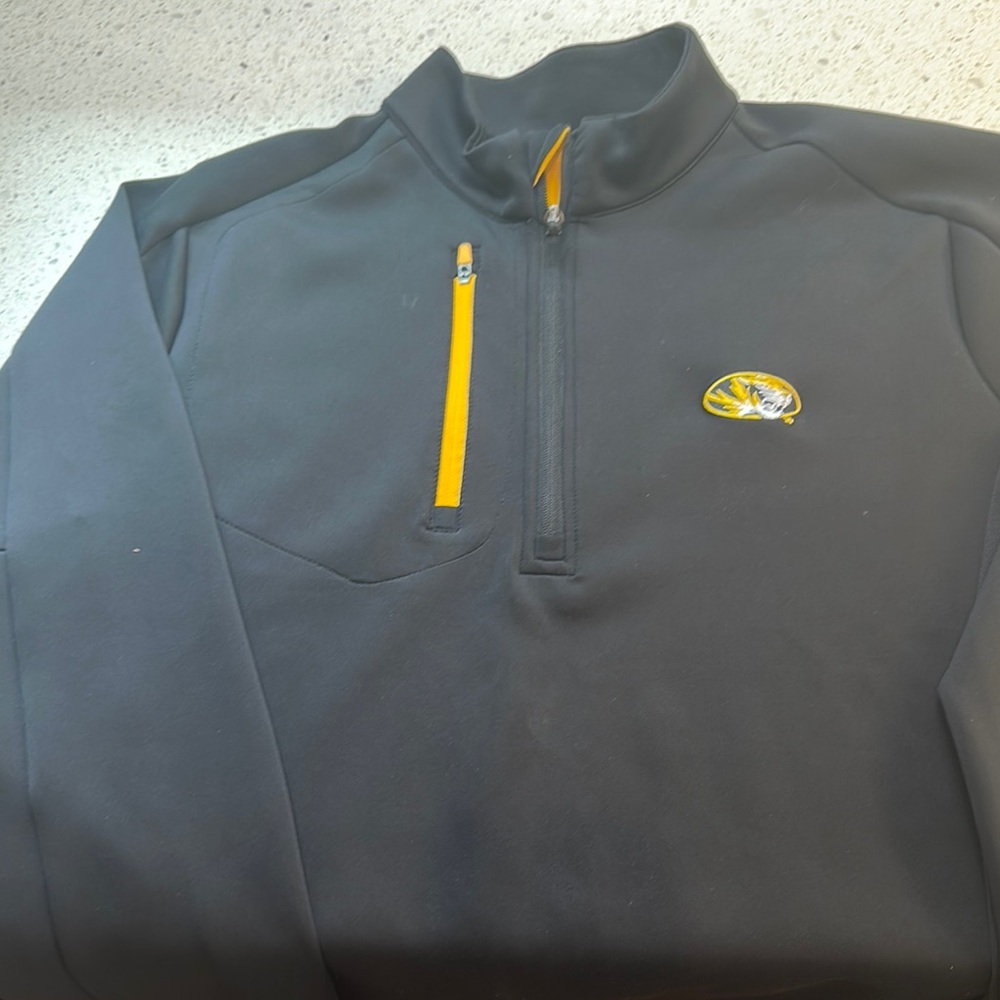 Mizzou Tigers emblazoned quarter zip top in polyester. Mesh side panels.